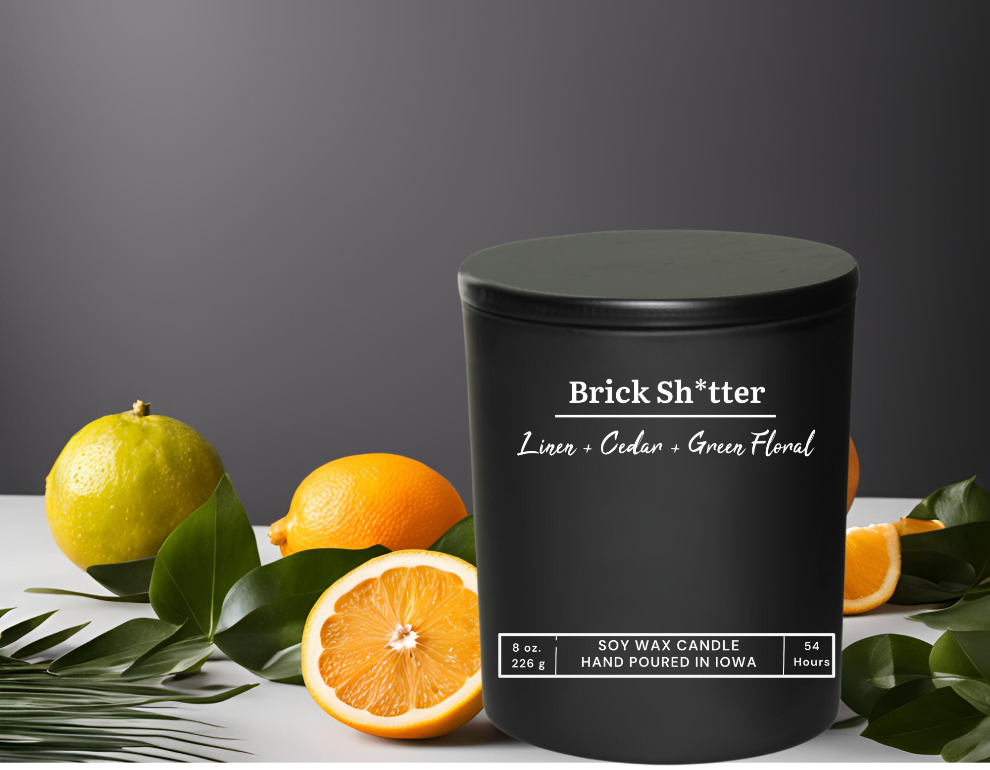 Black ceramic candle jar with black wooden lid - clean linen and citrus scented bathroom candle